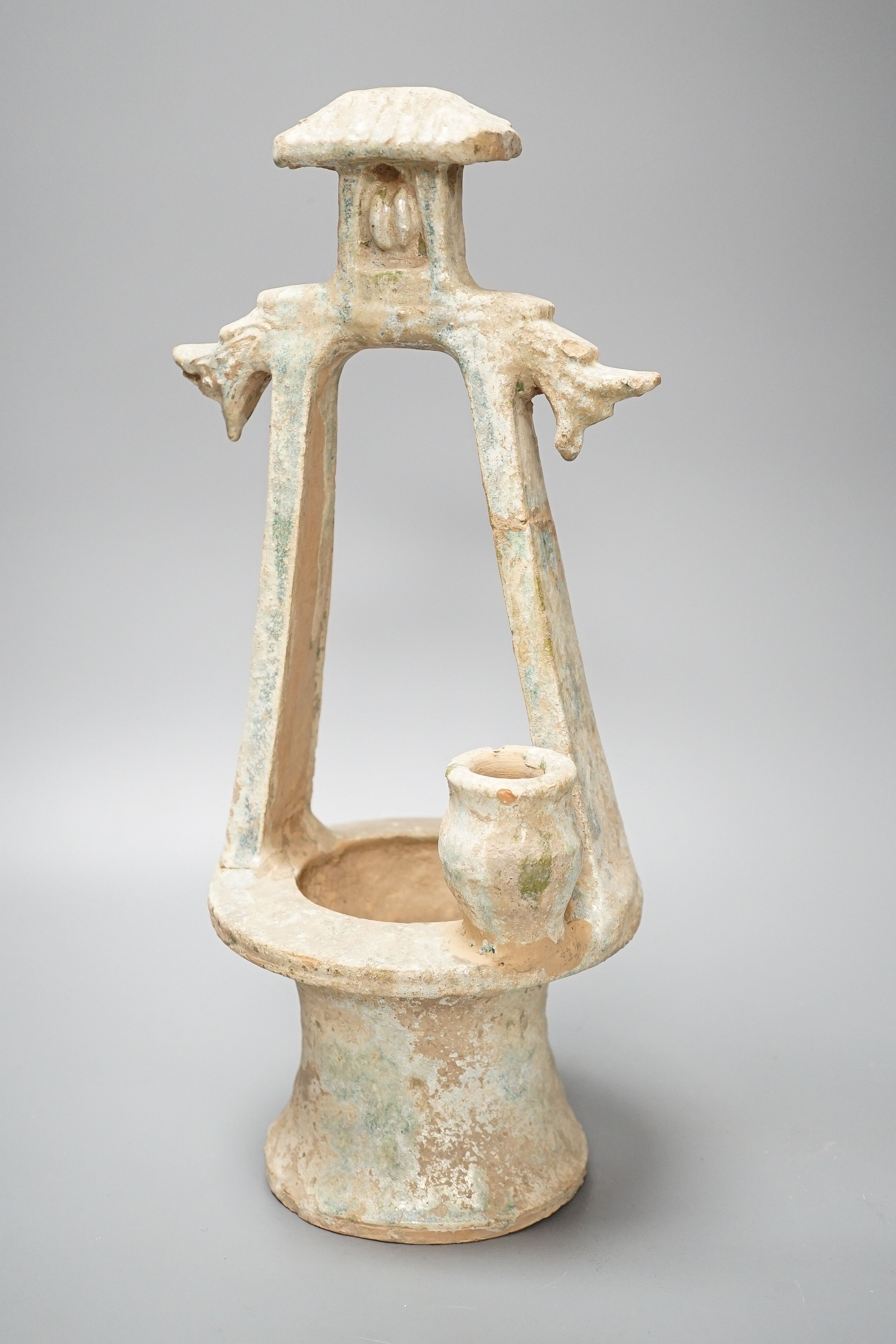 A Chinese Han dynasty green glazed model of a well, mineral iridescence to glaze, height 37cm